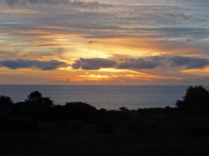 Sunset and a fishing boat by Jon Loveless