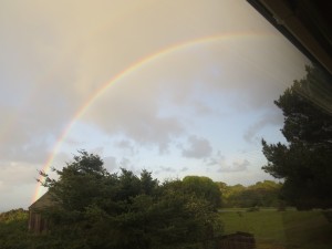 Rainbow after storm clouds by Robert Scarola