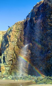 Rainbow in a seasonal waterfall at Black Point Beach by Allen Vinson